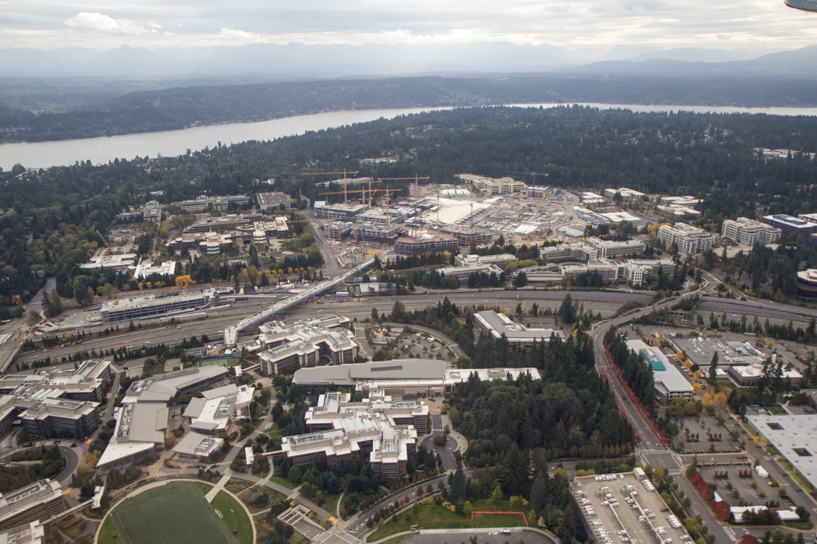 Aerial view of Microsoft's Redmond campus with ongoing construction and surrounding landscape.