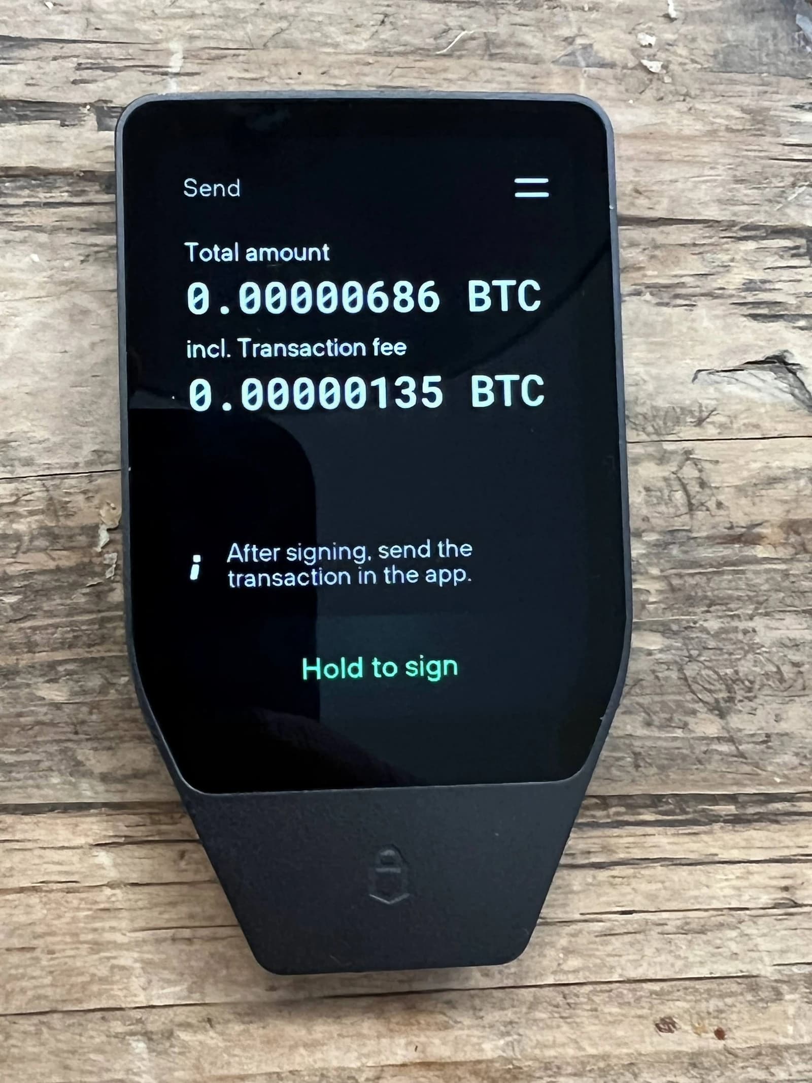 Trezor hardware wallet displaying a pending Bitcoin transaction.