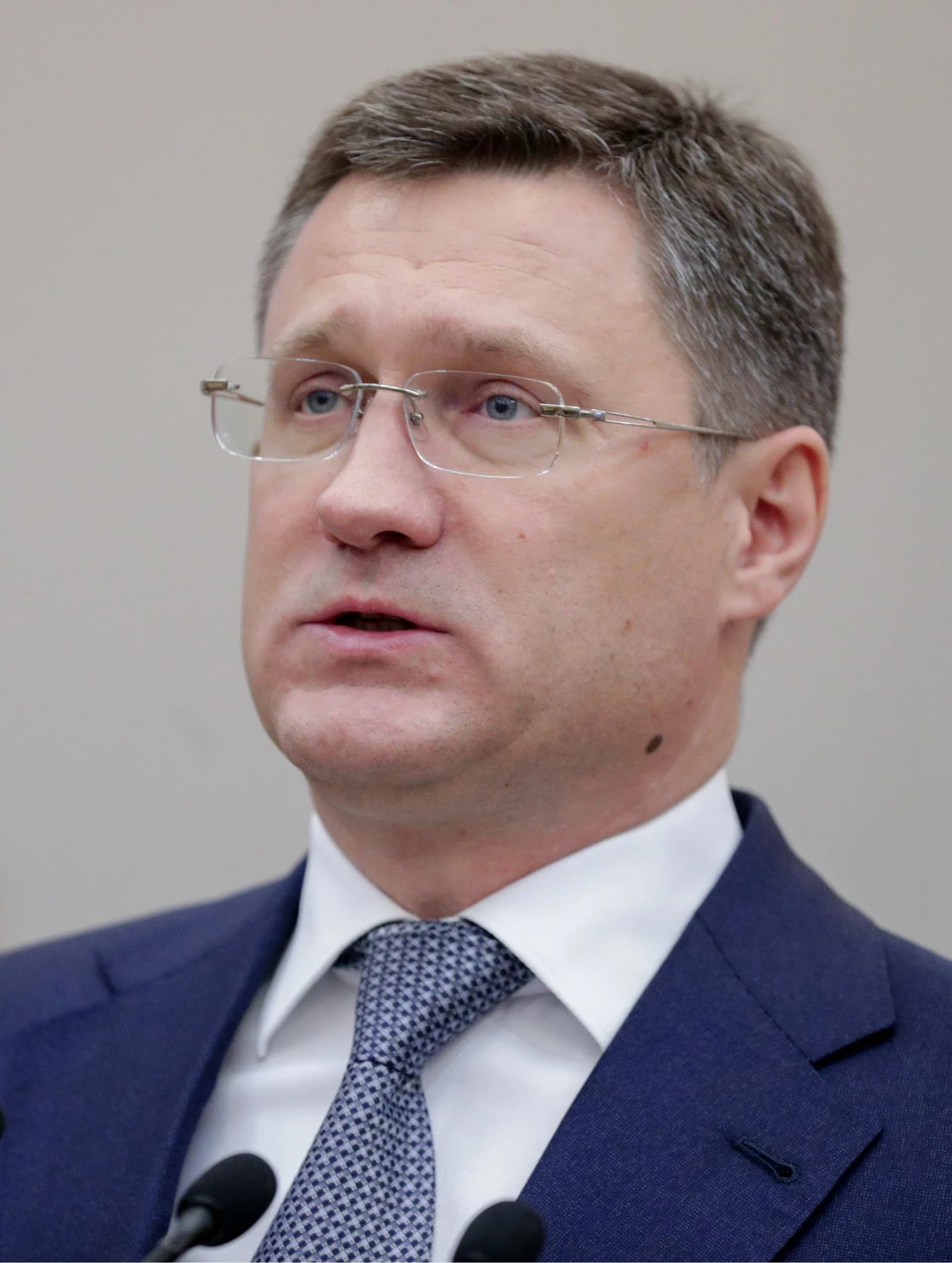 Alexander Novak, Russian politician, speaking at microphones during an event.