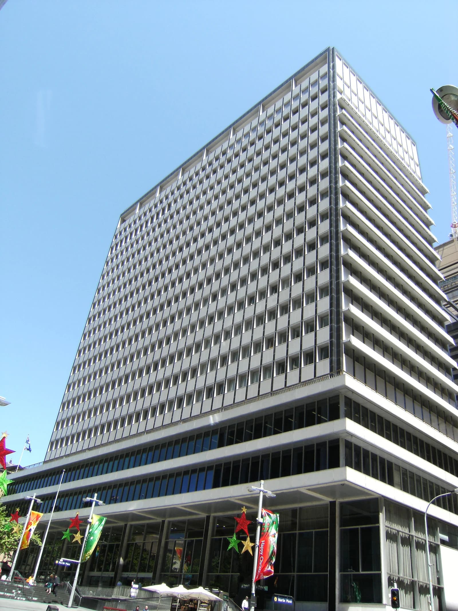 Exterior of the RBA Building, a large white multi-story office building against a blue sky.