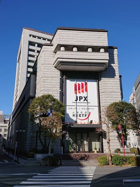 Exterior view of the Tokyo Stock Exchange main building on a clear day.