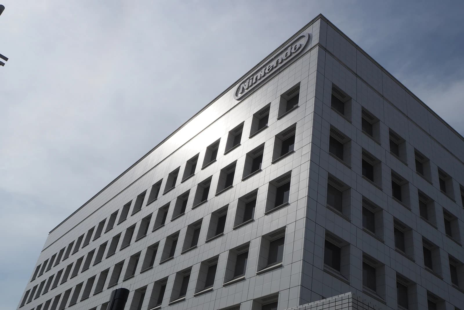 Nintendo Headquarters building exterior with company logo visible on the upper corner.