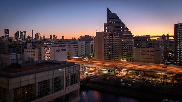 Buildings and a highway in the Shibaura district of Tokyo at dusk.