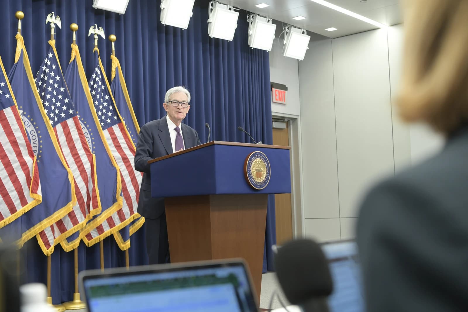 Jerome Powell, Chairman of the Federal Reserve, speaking at a podium during a press conference.