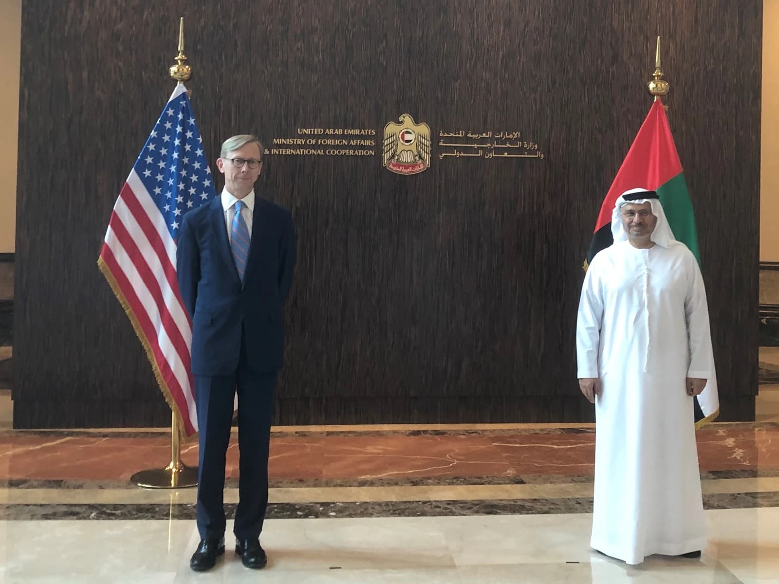 Anwar Gargash, UAE Minister of State for Foreign Affairs, standing with Brian Hook, US Special Representative.