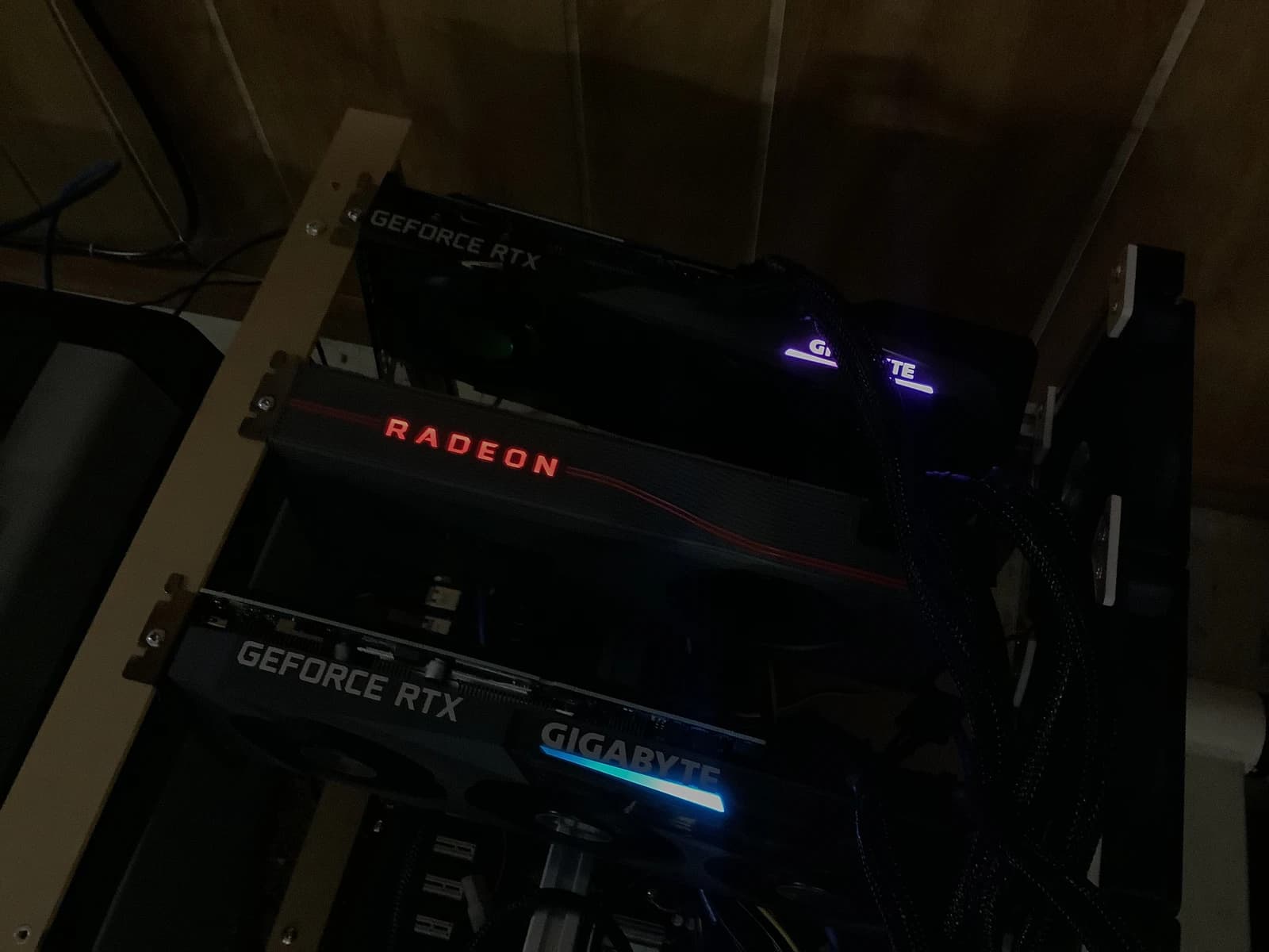 Close-up of a cryptocurrency mining rig with glowing graphics cards.