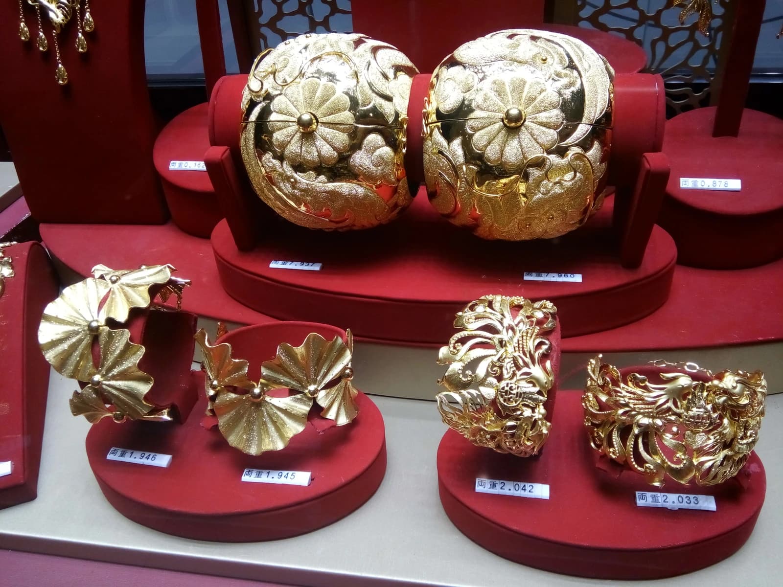 Gold bracelets and ornaments displayed in a Chow Tai Fook jewelry store in Hong Kong.