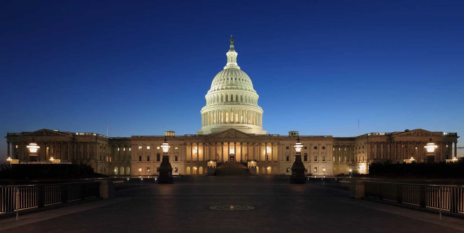 The United States Capitol building, Washington D.C., illuminated at dusk.