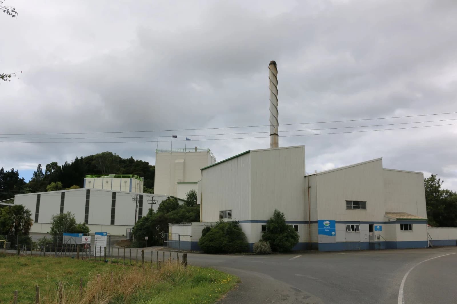 Exterior of the Fonterra Dairy Factory in Takaka, New Zealand, with a tall smokestack.