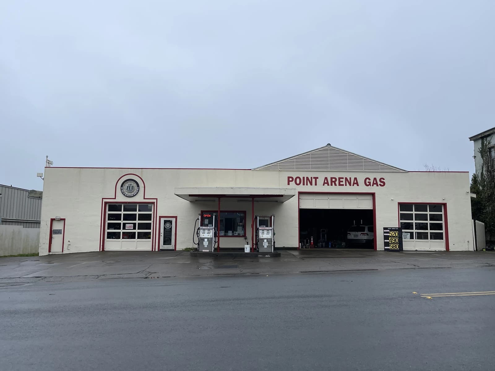 Point Arena Gas station building with gas pumps and pricing display.