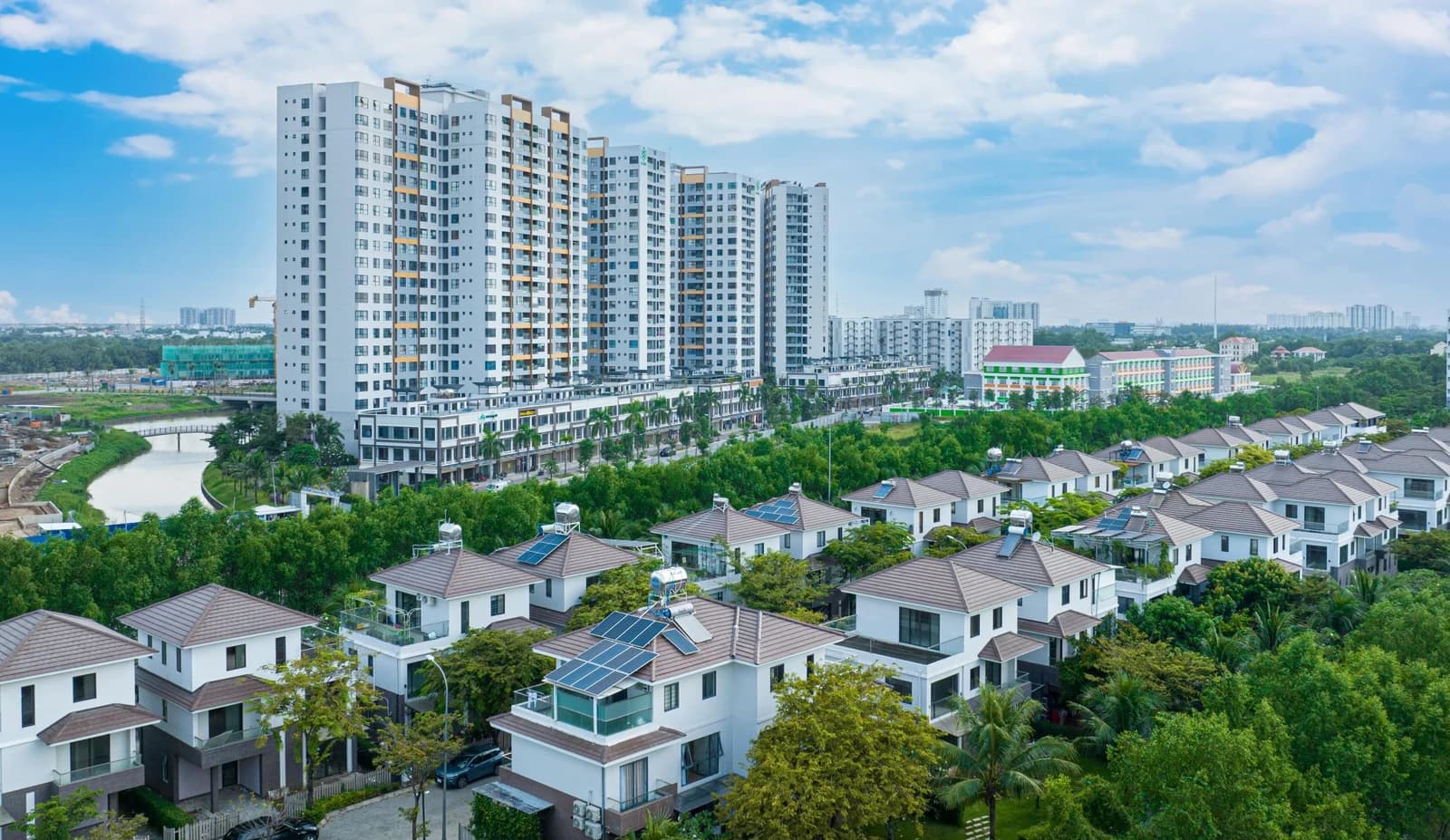Aerial view of a large residential development with modern houses and apartment buildings.