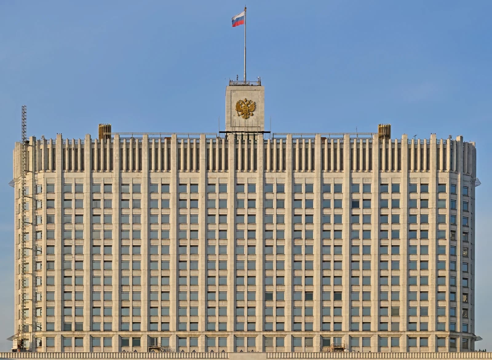 The Russian Government Building facade with a flag and national emblem visible.