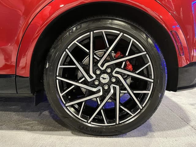 Close-up of a stylish wheel and tire on a red Ford Mustang Mach-E.