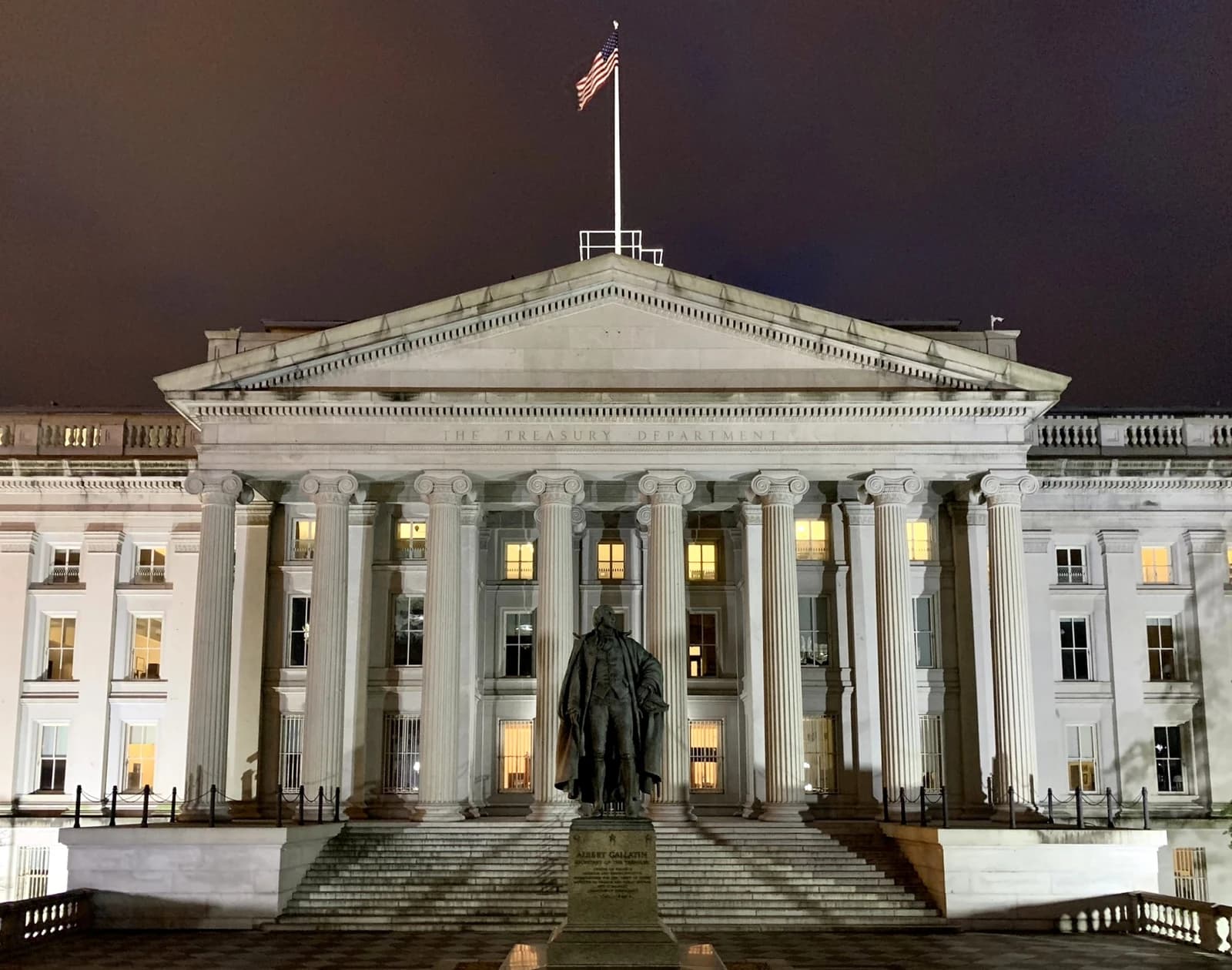 The United States Treasury Department building, with a statue of Albert Gallatin in front.