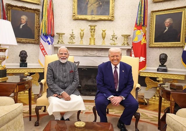 President Donald Trump and Prime Minister Narendra Modi are seated in chairs inside the White House.