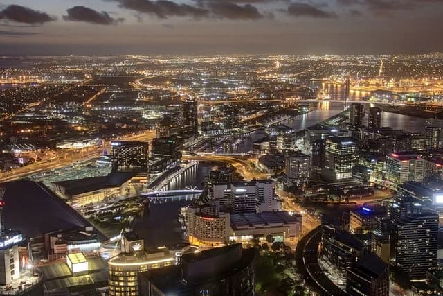 Aerial night view of Southbank and Bolte Bridge over the Yarra River in Melbourne.