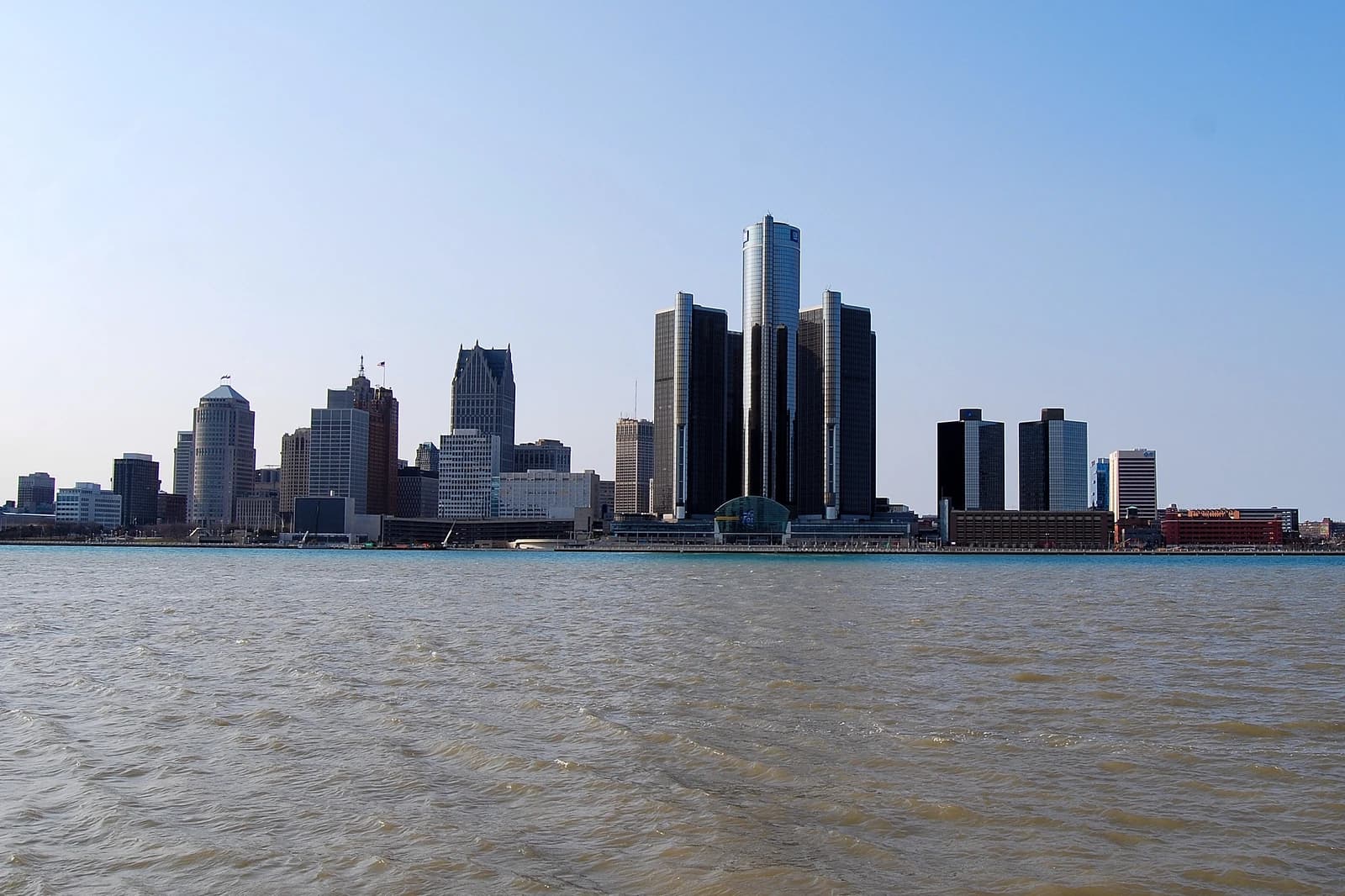 Detroit skyline with the Renaissance Center complex prominently featured from across a body of water.