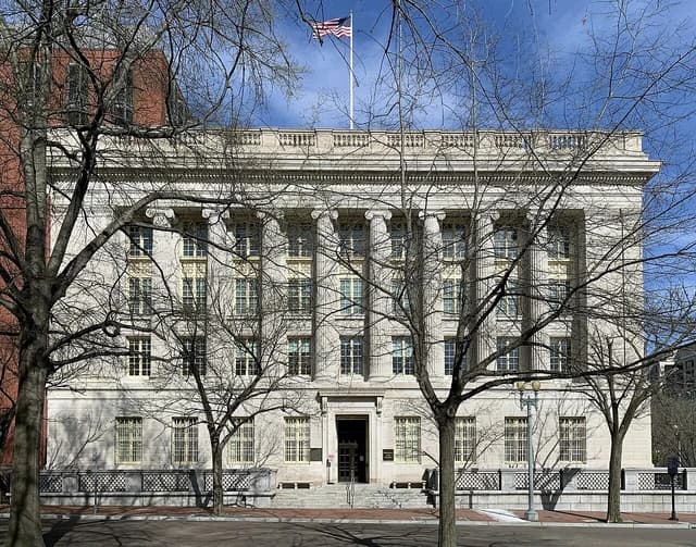 United States Treasury Annex building facade on a sunny day with bare trees.