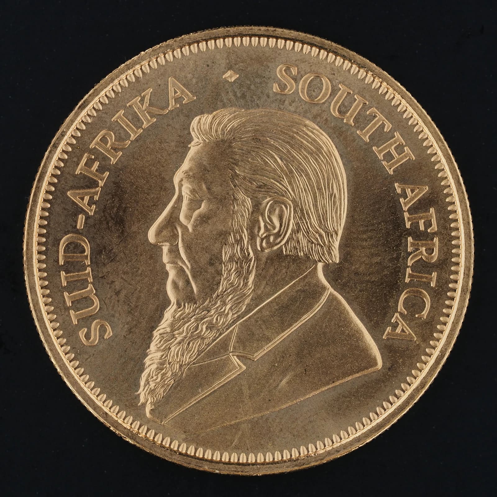 Obverse side of a South African Krugerrand gold coin with a portrait of Paul Kruger.