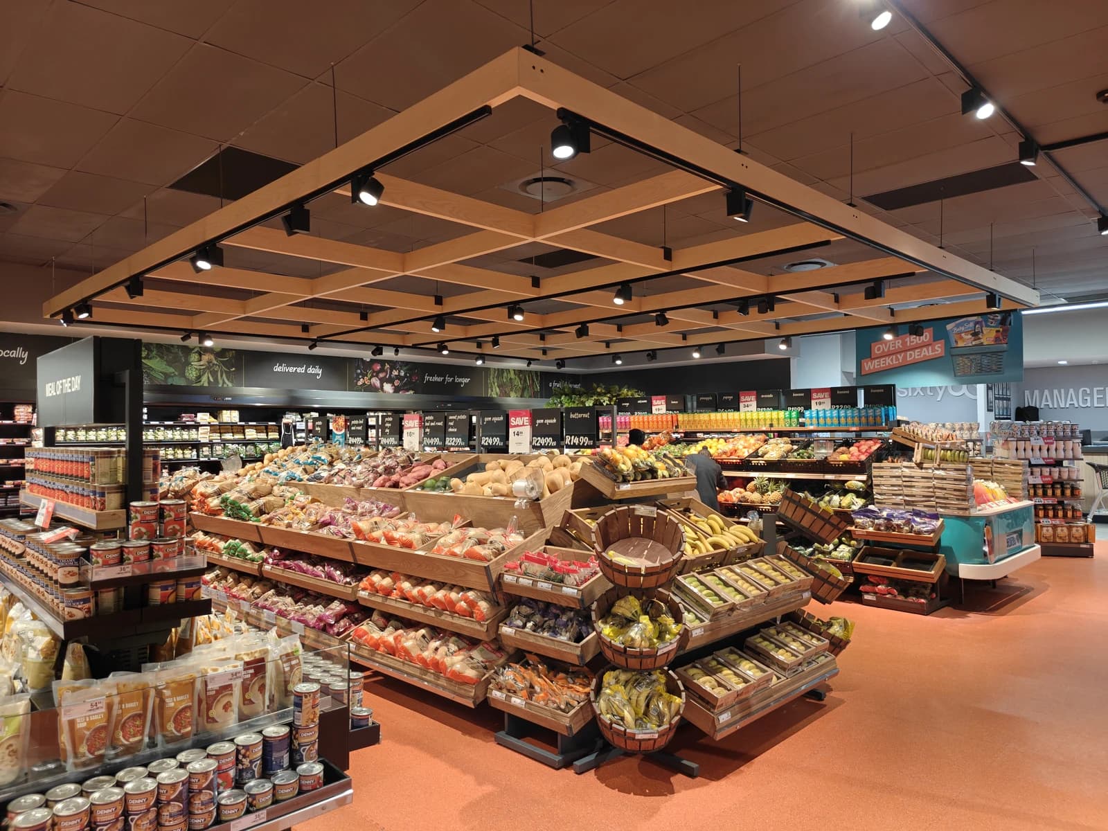 Produce section of a grocery store with fruits and vegetables on display.