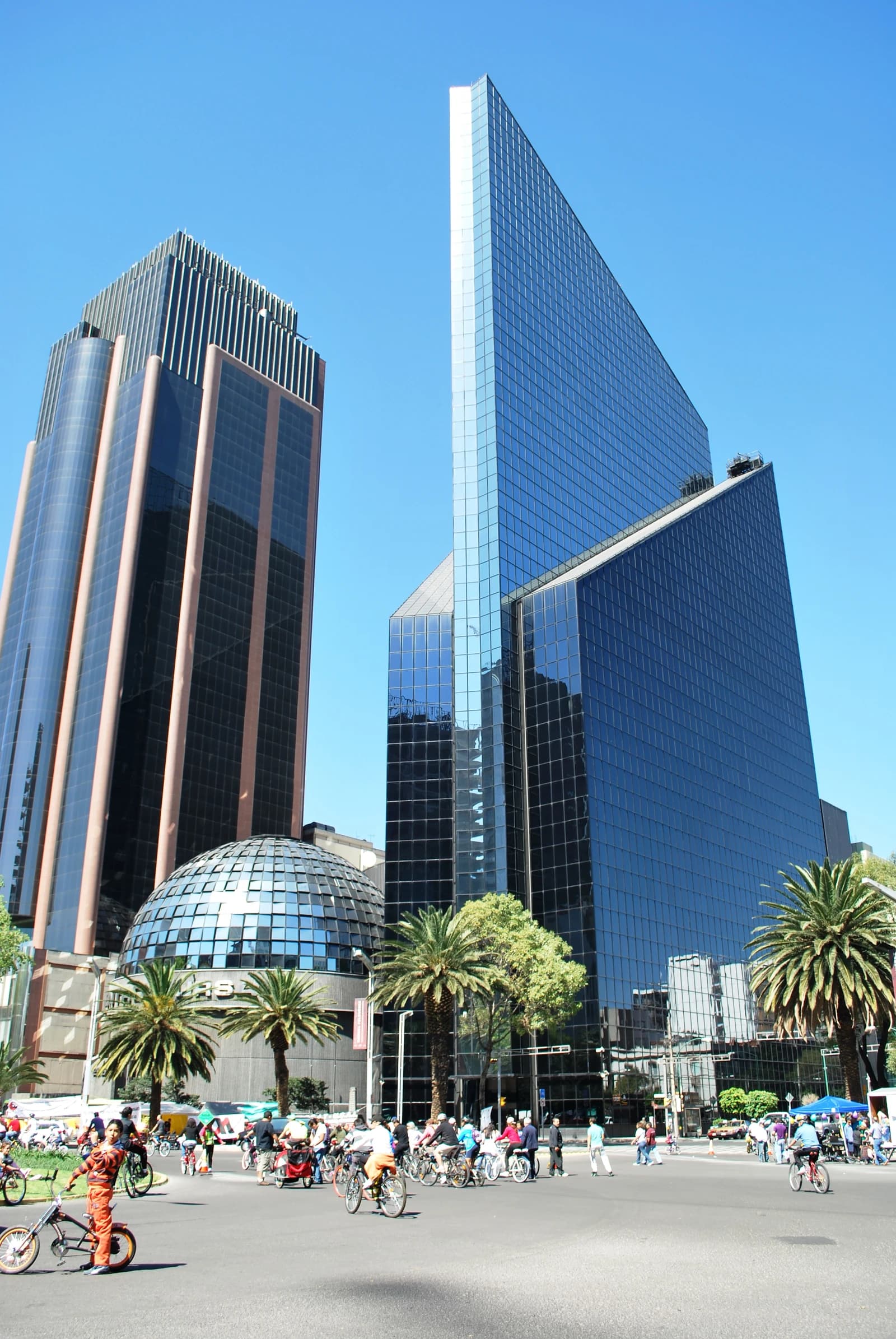 Modern high-rise buildings and the distinct dome of the Mexico City Stock Exchange.