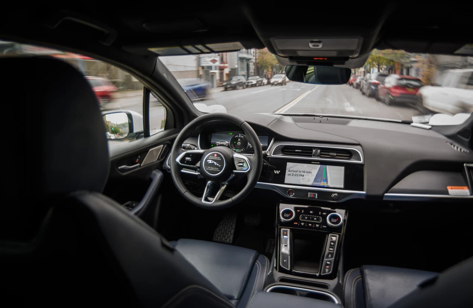 Interior of a Waymo Jaguar I-Pace robotaxi driving on a city street.