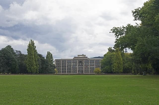 The Treasury Building in Canberra, Australia, from Parkes Place, under a cloudy sky.