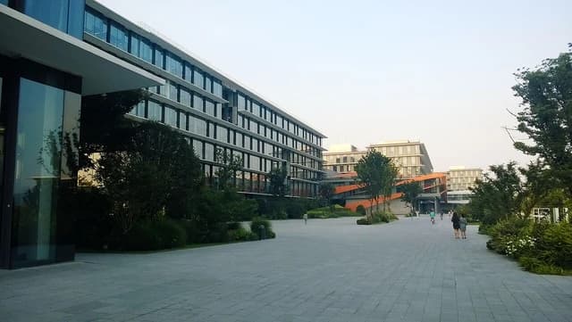 Modern buildings with glass facades and surrounding green landscaping at Alibaba's Xixi Campus.