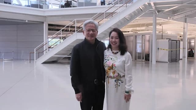 Director Lê Nguyễn Thiên Nga and NVIDIA Founder and CEO Jensen Huang standing indoors.