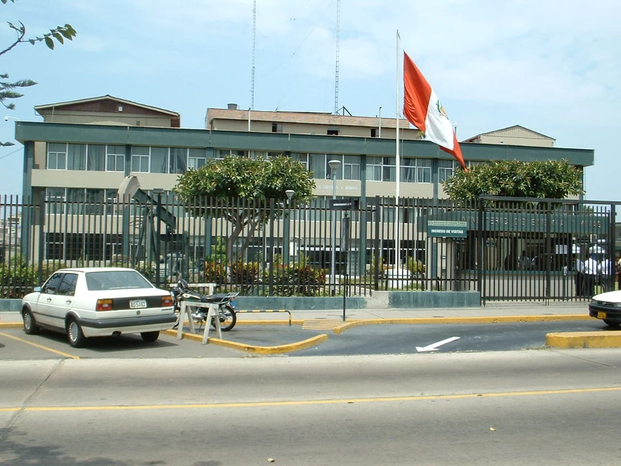Ministry of Energy and Mines building with a Peruvian flag flying above.