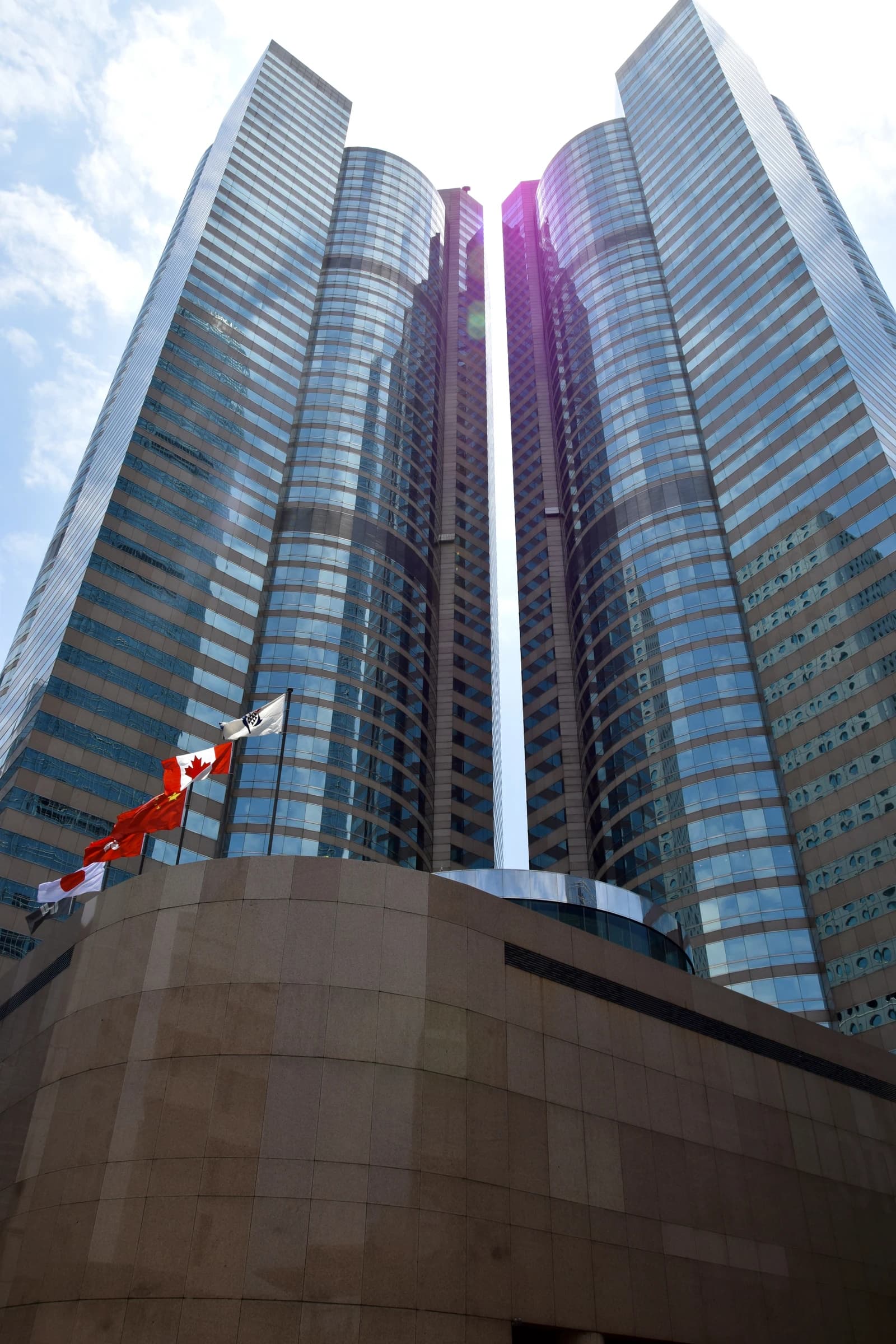 Exchange Square, home of the Hong Kong Stock Exchange, towers towards a bright sky.