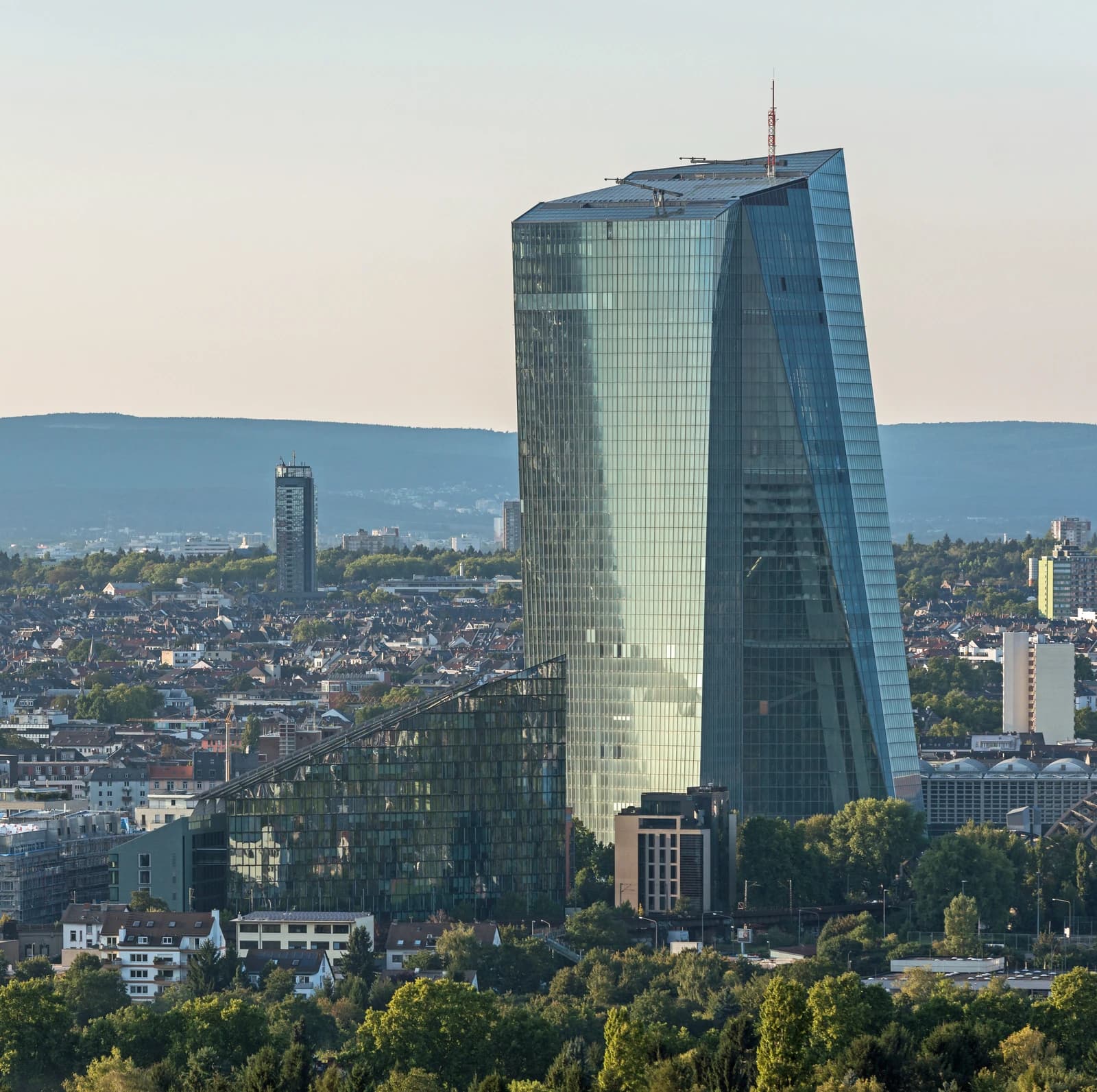European Central Bank headquarters building in Frankfurt, Germany, against a city skyline.