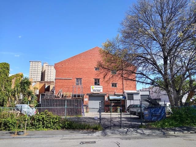 Rear of the Former Austral Picture Theatre, a red brick building with an industrial facade.