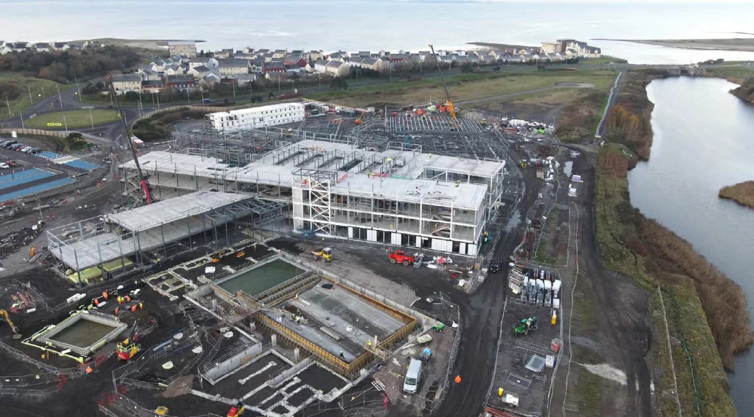Aerial view of Pentre Awel construction site with multiple buildings in various stages of completion.