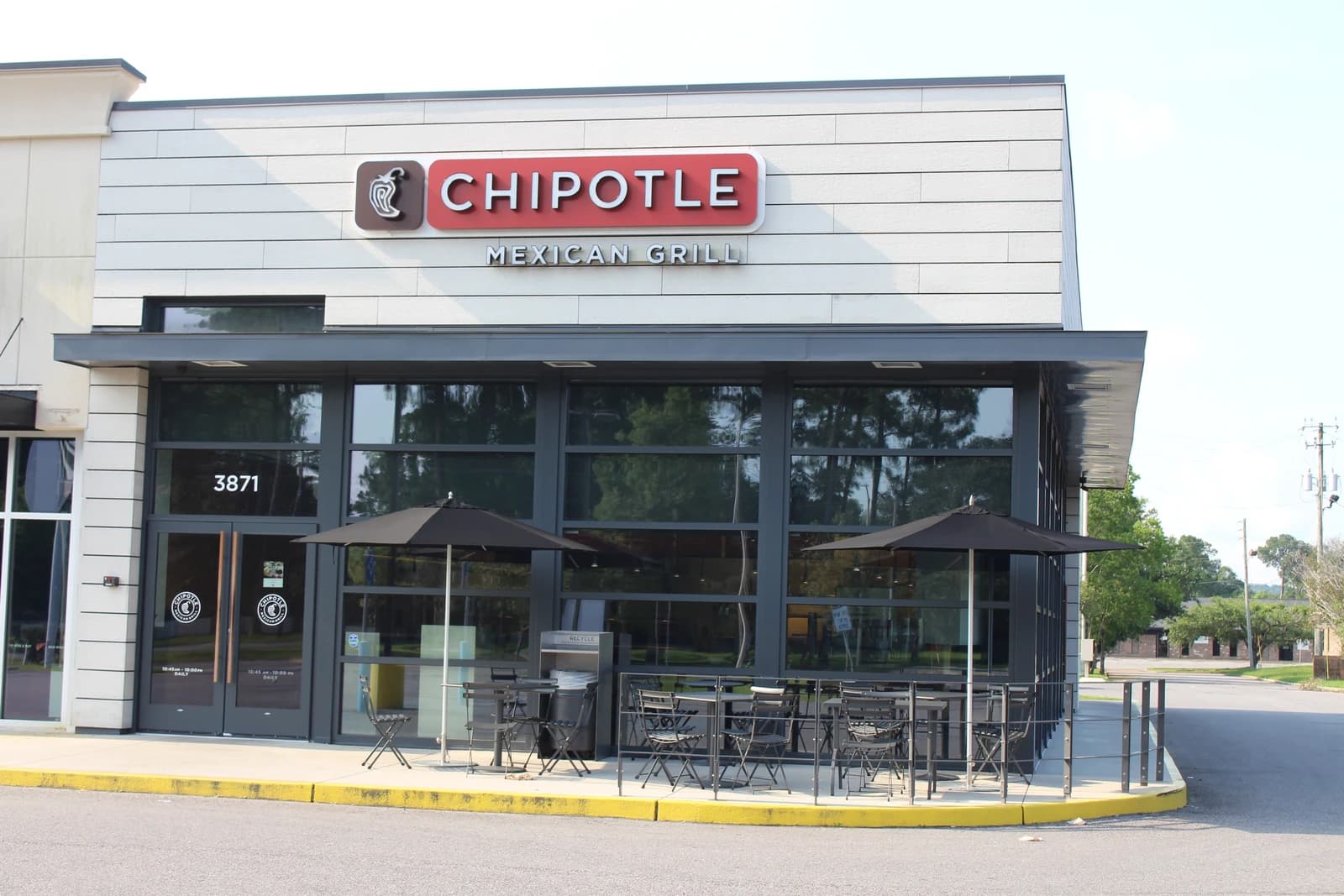 Exterior of a Chipotle Mexican Grill restaurant building with outdoor patio seating.