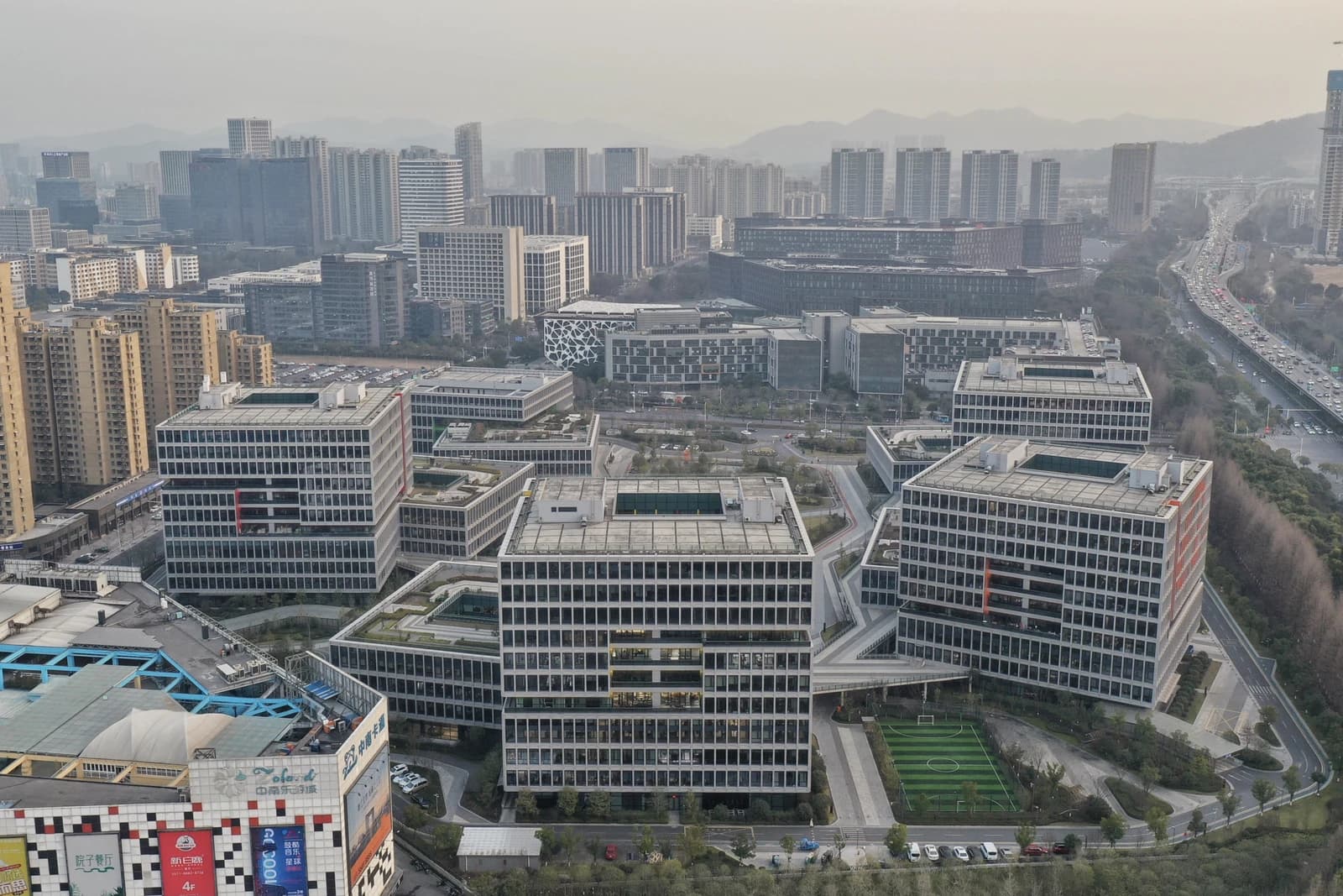 Aerial view of the modern, block-like buildings of the Alibaba Center campus in Hangzhou, China.