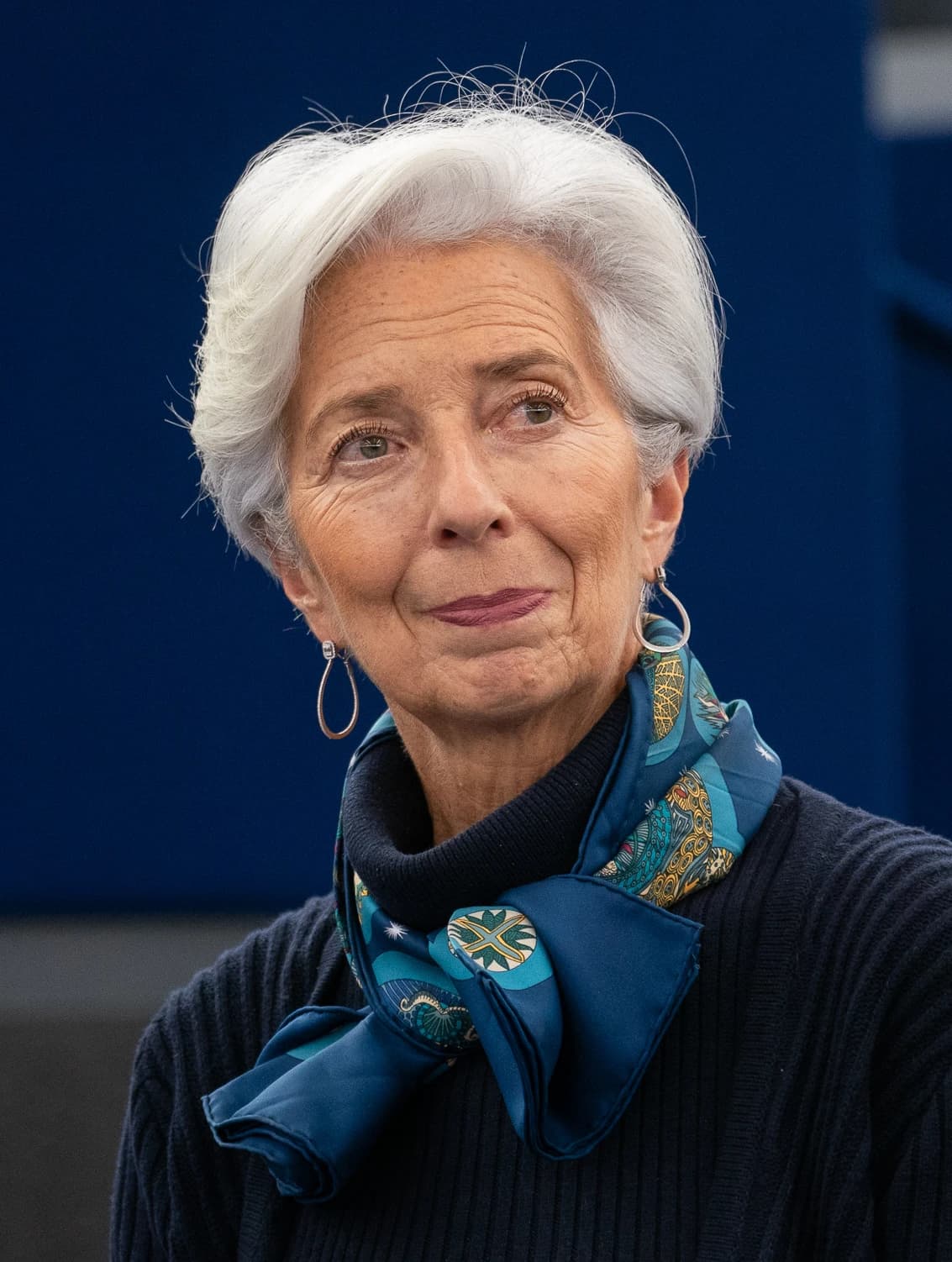 Christine Lagarde, President of the European Central Bank, looking away in a formal setting.