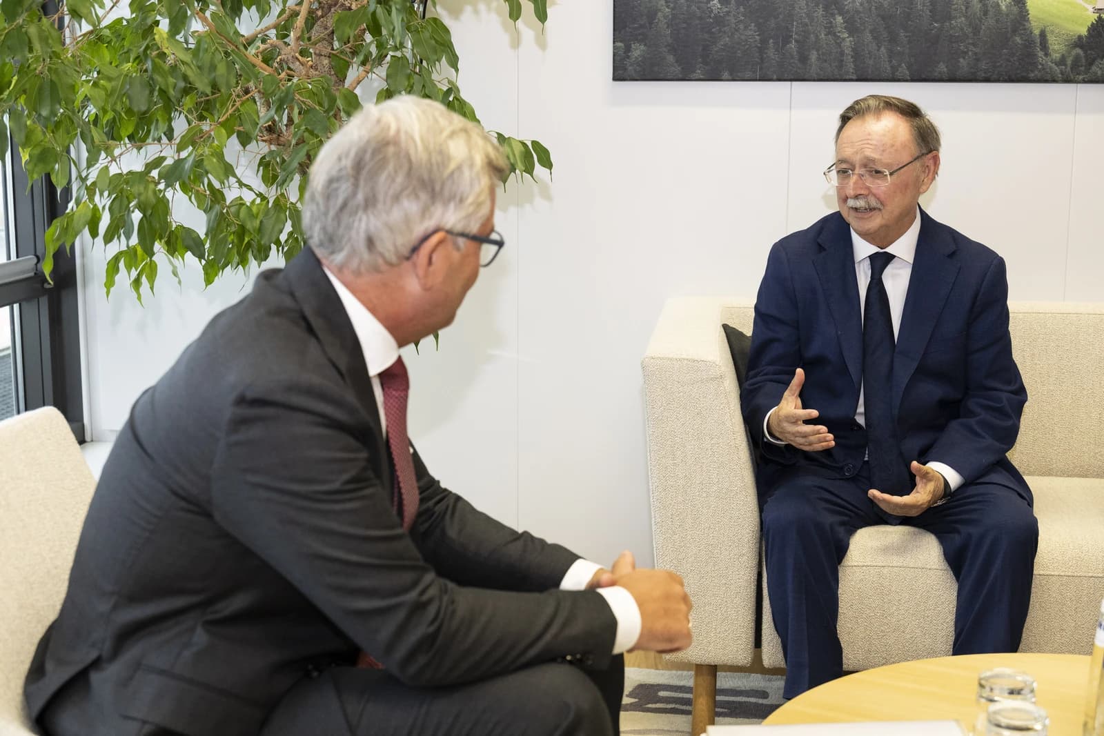 Juan Jesús Vivas, Mayor-President of Ceuta, sitting and gesturing while talking to another man.