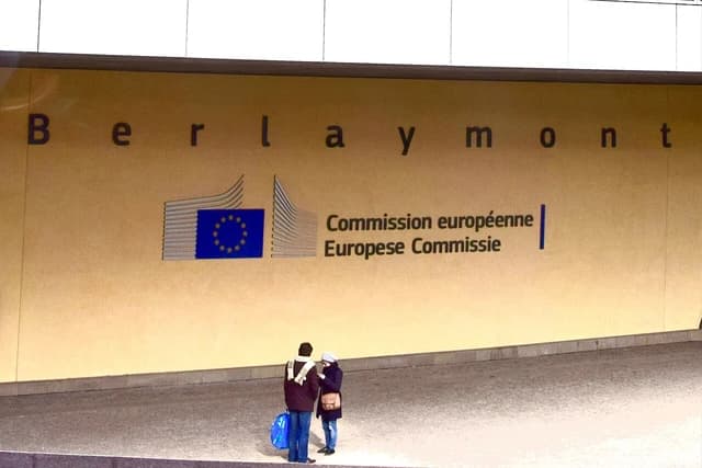 People standing outside the European Commission headquarters, The Berlaymont Building, Brussels, Belgium.