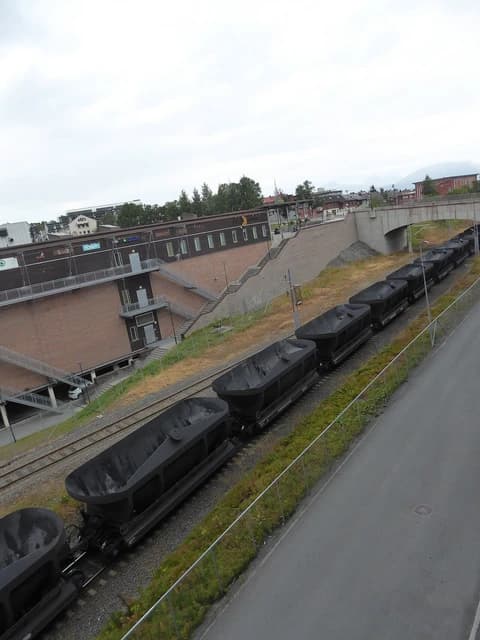 Train cars filled with iron ore on tracks in Narvik, Norway.