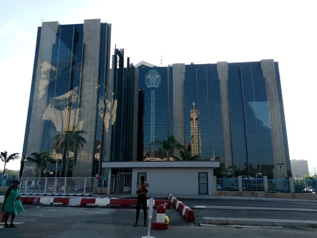 Central Bank of Nigeria building in Abuja with modern glass and stone architecture.