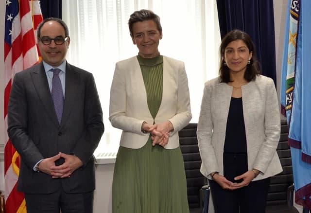 Lina Khan, Margrethe Vestager, and Jonathan Kanter standing together for a photo.
