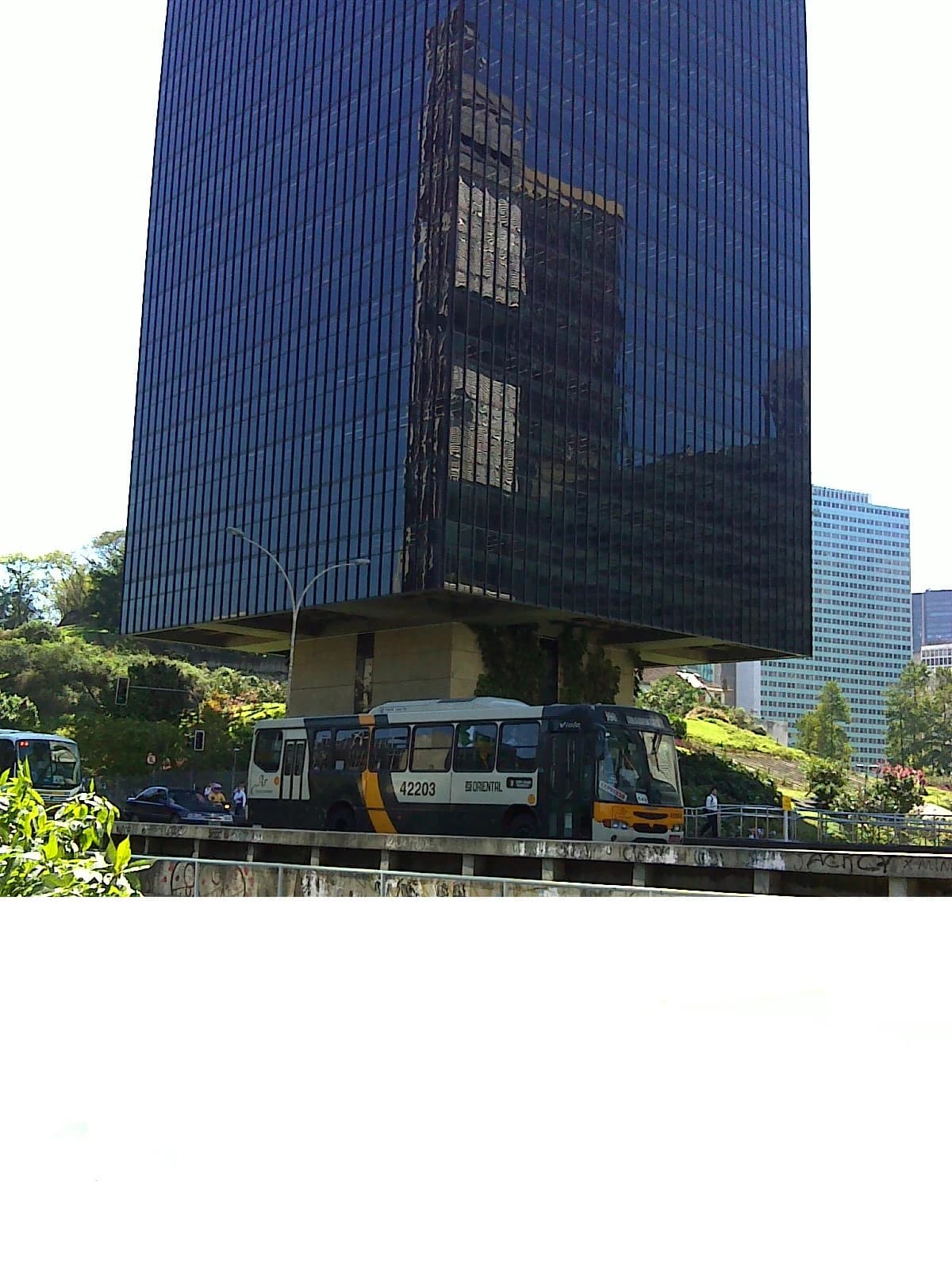 Exterior view of the BNDES headquarters building with dark reflective windows in Rio de Janeiro.