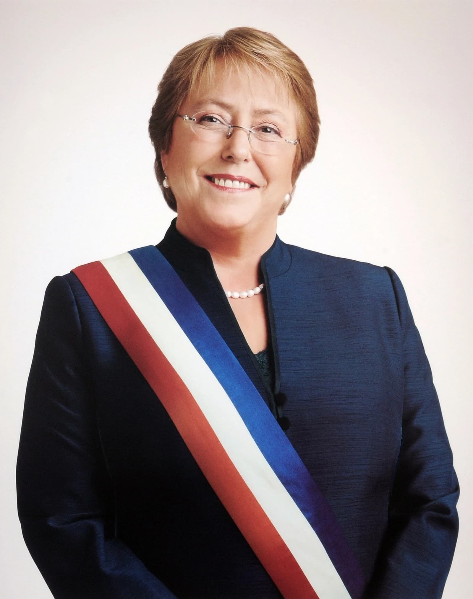 Michelle Bachelet, former President of Chile, smiling for a formal portrait.