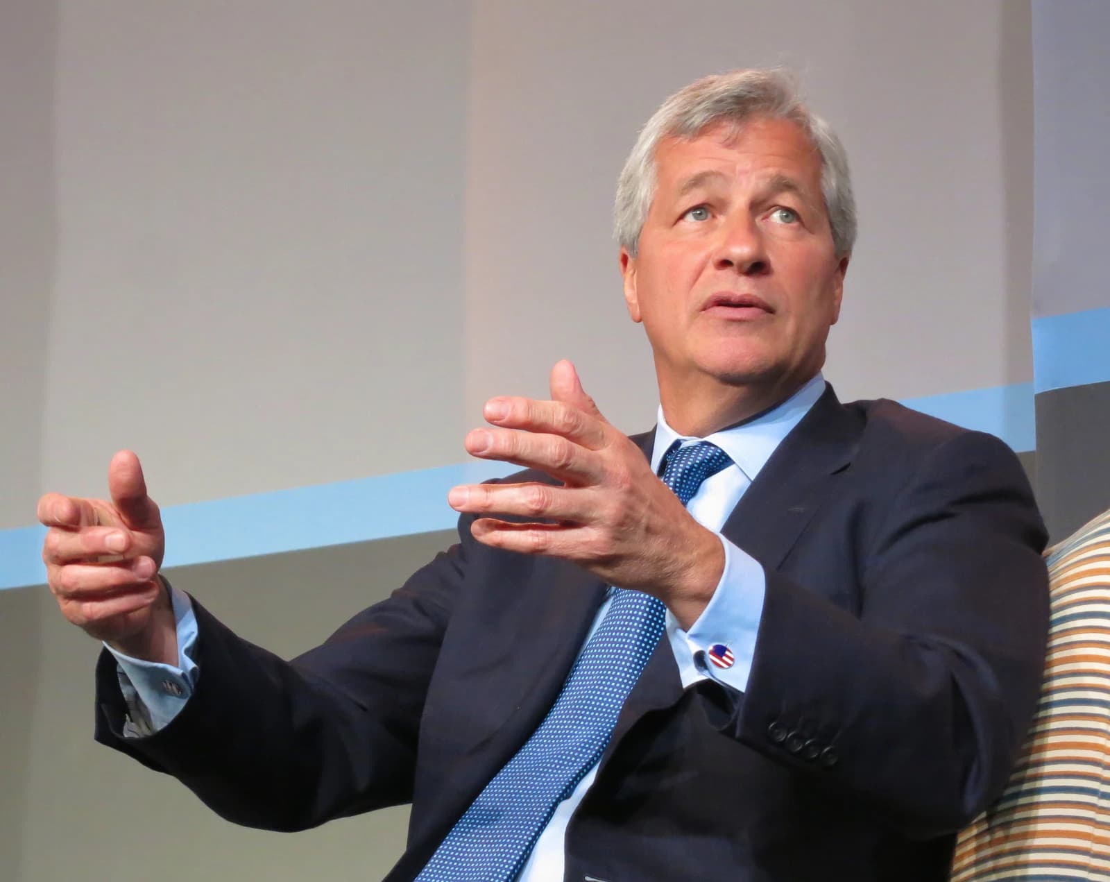 Jamie Dimon, CEO of JPMorgan Chase, speaking and gesturing during a presentation.