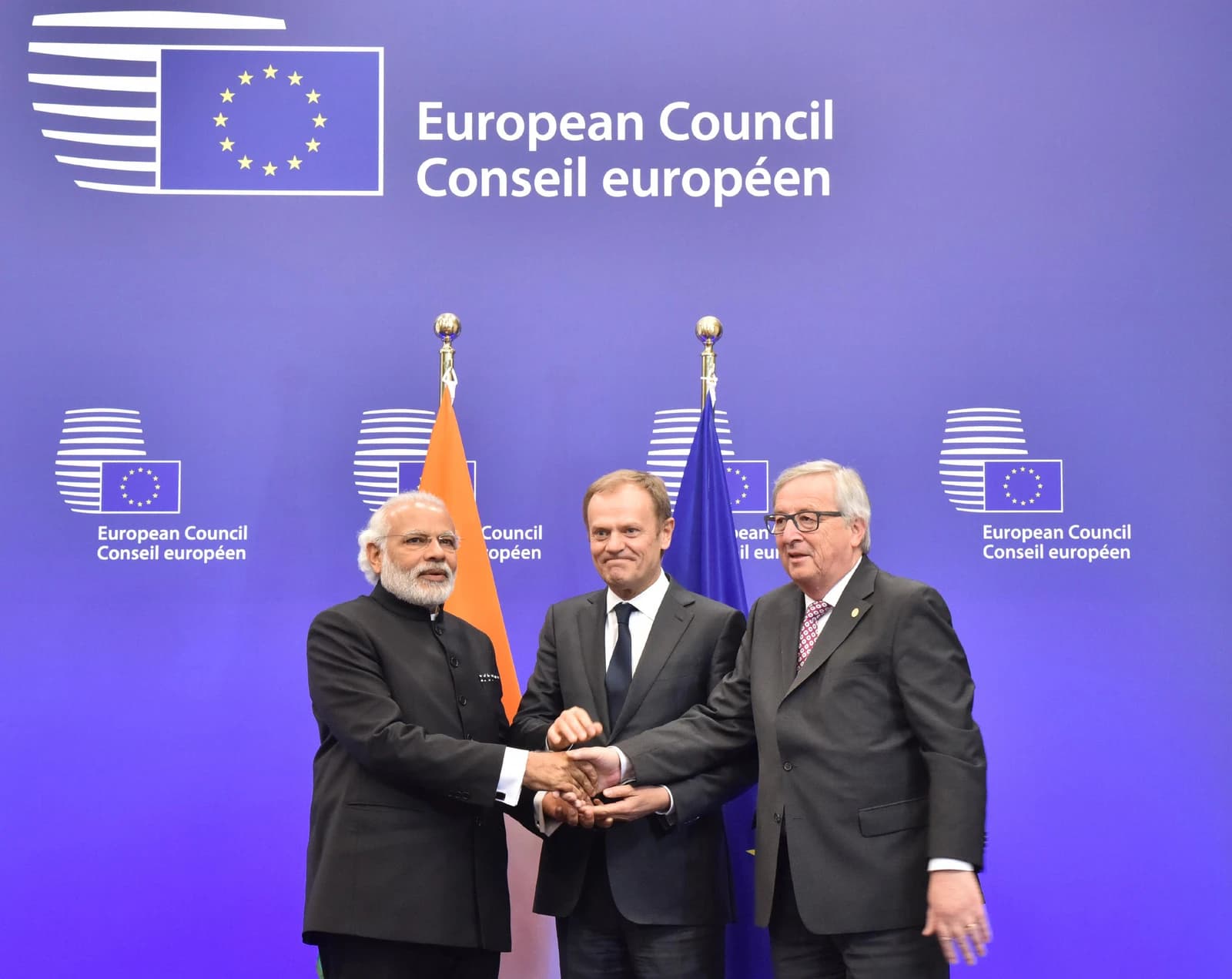 Narendra Modi, Donald Tusk, and Jean-Claude Juncker shaking hands at the EU-India Summit in Brussels.