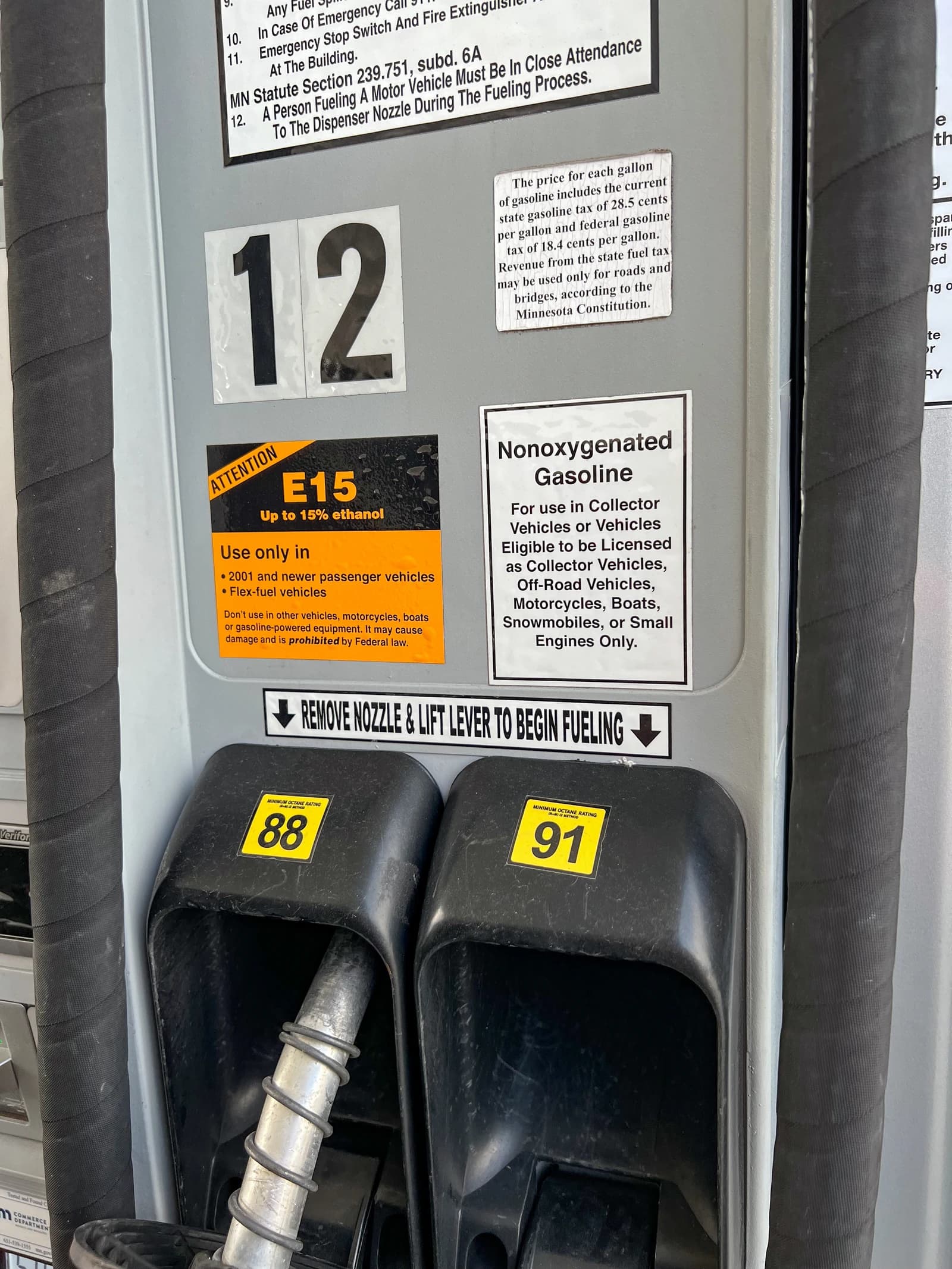 Close-up of gas pump nozzles displaying 88 and 91 octane ratings.