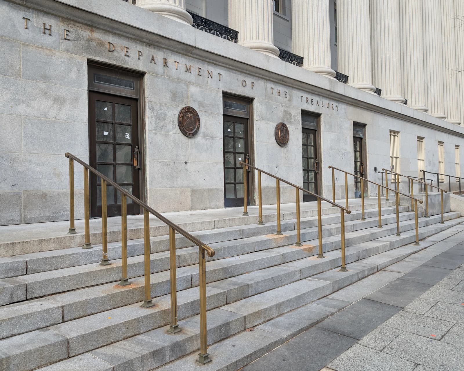 Exterior of the Department of the Treasury building with 'THE DEPARTMENT OF THE TREASURY' inscribed.