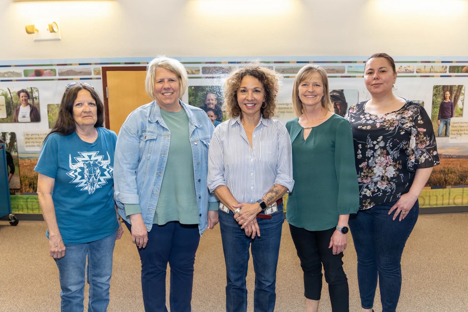 Five women from USDA Rural Development and Thunder Valley Community Development Corporation pose together.
