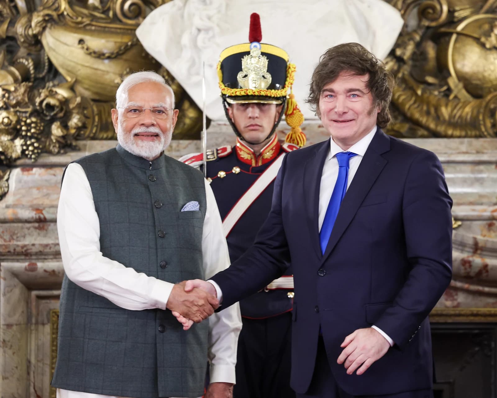 Argentine President Javier Milei shakes hands with Indian Prime Minister Narendra Modi.